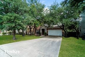 San Antonio house for rent - a house with a driveway and trees in front of it