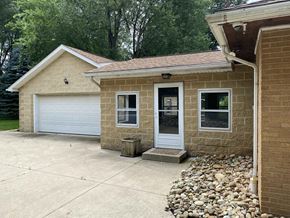 Canton apartment for rent - A house with a white garage door and a brown brick exterior.