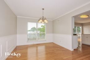 O'fallon house for rent - an empty dining room with wood floors and a window