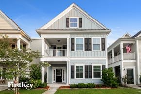 Summerville house for rent - a white house with an flag on the balcony