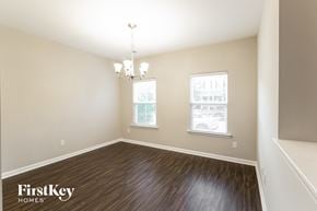 Summerville house for rent - a dining room with wood flooring and two windows