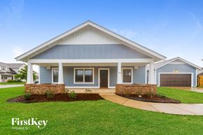 Calera house for rent - A house with a blue exterior and a brick pillar in front.