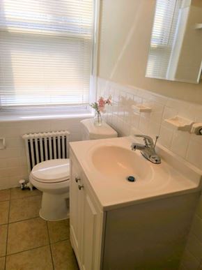 Washington apartment for rent - A white toilet sits next to a sink in a bathroom.