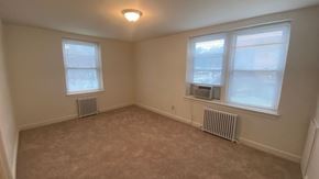 Washington apartment for rent - A room with two windows and radiators under the windows.