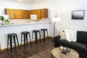 Ames apartment for rent - a living room with a bar and a kitchen with stools