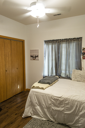 Ames apartment for rent - a bedroom with a bed and a window and a wardrobe