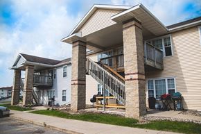 Ames apartment for rent - the front of a house with a porch and a staircase