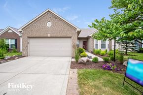 Noblesville house for rent - a brick house with a garage door and a driveway