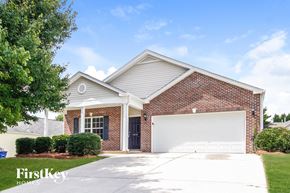 Winsten-Salem house for rent - a small brick house with a white garage door