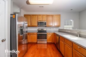 Winsten-Salem house for rent - a kitchen with wooden cabinets and stainless steel appliances