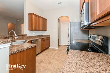 Red Oak house for rent - A kitchen with brown cabinets and a granite countertop.