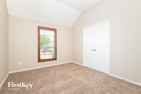 Red Oak house for rent - A room with a white door and a window with a view of trees.