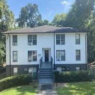 Atlanta apartment for rent - a white house with black stairs and a lawn