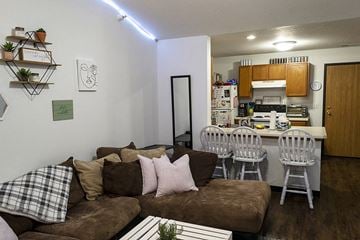 Ames apartment for rent - a living room with a couch and a kitchen with a table
