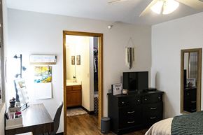 Ames apartment for rent - a small bedroom with a tv and a dresser