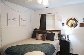Ames apartment for rent - a bedroom with a bed and a mirror on the wall
