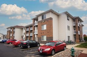 Ames apartment for rent - a row of cars parked in front of an apartment building