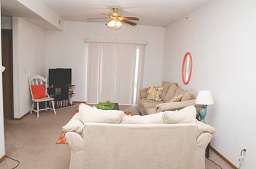Ames apartment for rent - a living room with a couch and a ceiling fan