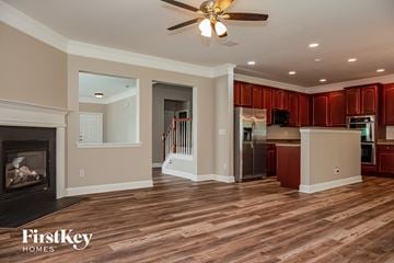 Charlotte house for rent - a renovated living room with a fireplace and a kitchen