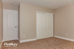 Charlotte house for rent - a bedroom with two closets and a carpeted floor