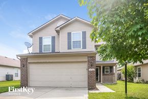Noblesville house for rent - a house with a white garage door and a tree