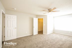 Noblesville house for rent - a bedroom with a ceiling fan and a door to a closet
