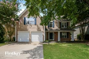 Marietta house for rent - a house with a white garage door and a lawn