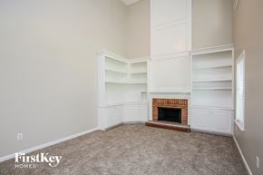 Marietta house for rent - a living room with a fireplace and white shelves