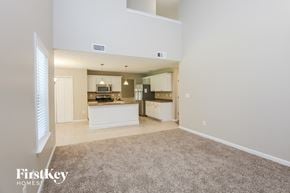 Marietta house for rent - an empty living room and kitchen with a carpeted floor
