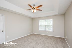 Marietta house for rent - a bedroom with carpet and a ceiling fan