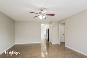 Baytown house for rent - A spacious room with a ceiling fan and tiled floor.