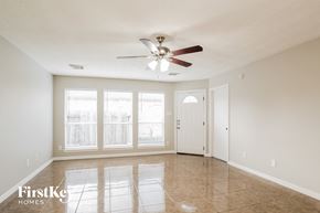 Baytown house for rent - A spacious room with a ceiling fan and tiled floor.