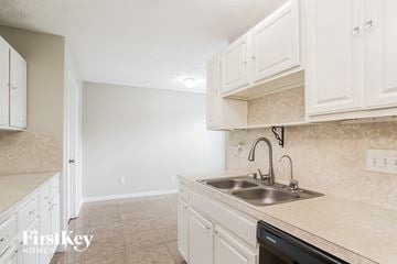 Baytown house for rent - A kitchen with a sink and cabinets.