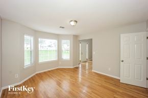 Ellenwood house for rent - the living room and dining room with wood floors and white walls