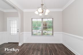 Colfax house for rent - the living room of a home with white walls and wood floors