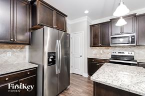 Colfax house for rent - a kitchen with stainless steel appliances and marble counter tops