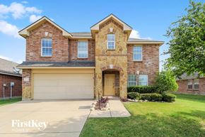 Fort Worth house for rent - front view of a brick house with a yellow garage door