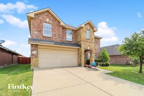 Fort Worth house for rent - a large brick house with a garage and a driveway