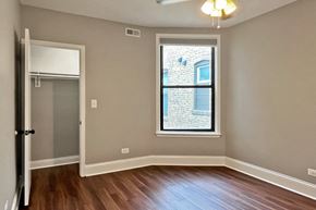 Oak Park apartment for rent - A room with a window and a ceiling fan.