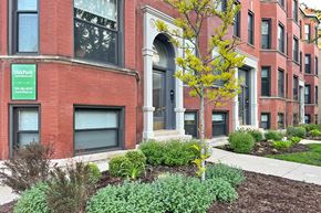 Oak Park apartment for rent - A tree with yellow leaves stands in front of a building with a sign that says Oak Park.