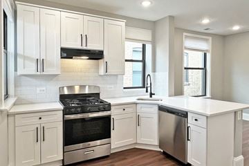 Oak Park apartment for rent - A kitchen with white cabinets and stainless steel appliances.