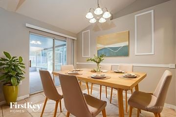 Deltona house for rent - A dining room with a wooden table and chairs.