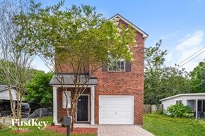 Jacksonville house for rent - a brick house with a white garage door