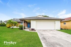 Orlando house for rent - A house with a garage and a driveway in front of it.