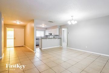 Orlando house for rent - A spacious room with a kitchen area in the background.