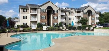 Fayetteville apartment for rent - A large apartment complex with a pool in front.