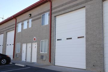 Boulder City apartment for rent - A building with a red trim and a white garage door.