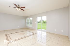 Groveland house for rent - a living room with a ceiling fan and a tiled floor