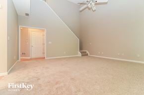 Acworth house for rent - A spacious room with a carpeted floor and a ceiling fan.