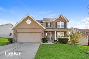 Saint Charles house for rent - a home with a driveway and lawn in front of it
